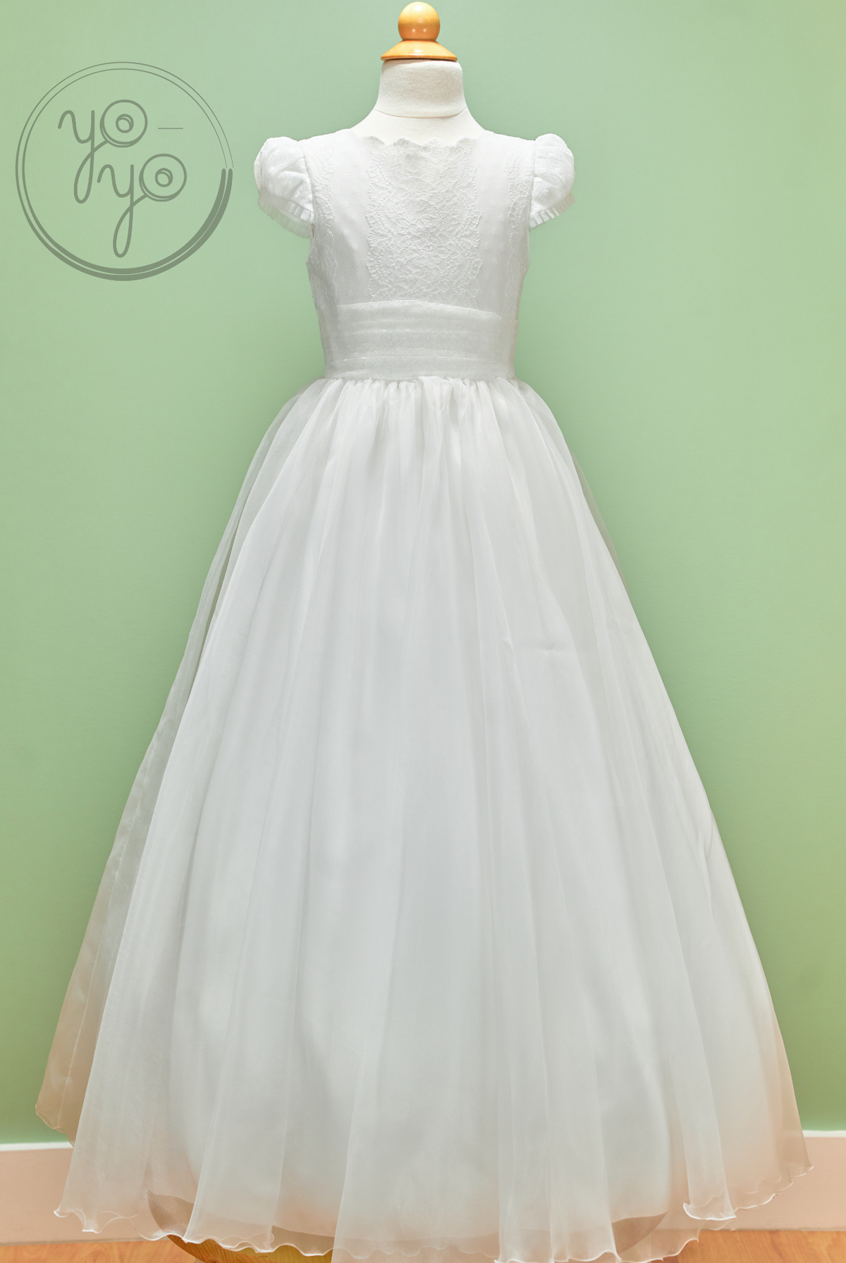 White Iris Dress by YoYo Boutique on a mannequin: floor-length with short puff sleeves, lace bodice, and a full embroidered tulle skirt.