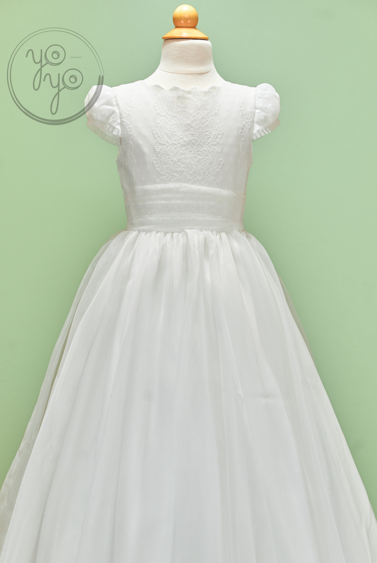 White Iris Dress on a mannequin, featuring a cap-sleeve embroidered tulle bodice and a floor-length skirt.