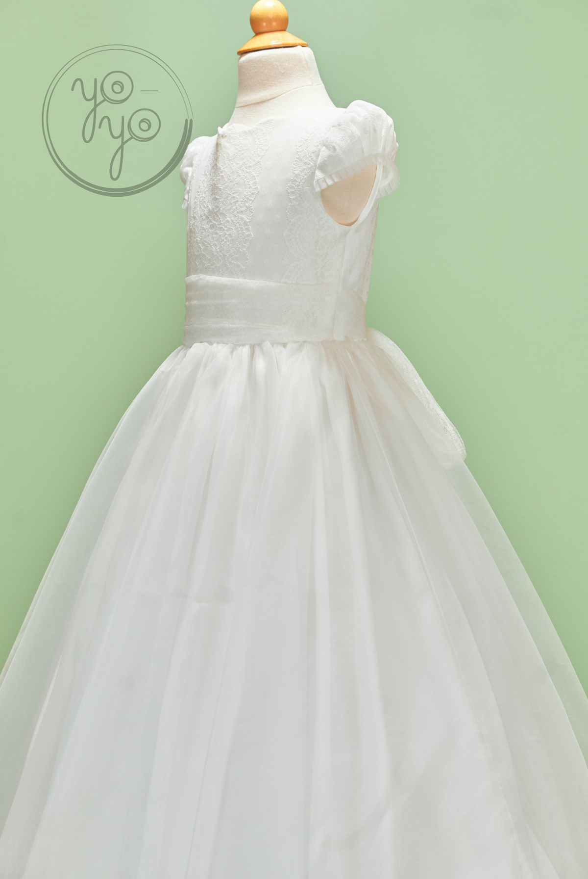 Iris Dress by YoYo Boutique: white First Communion dress on a mannequin with an embroidered tulle bodice, ruffled cap sleeves, and a full skirt.