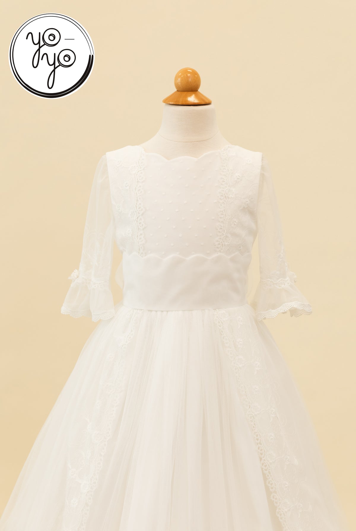 YoYo Boutique Senna Dress on a mannequin featuring a scalloped neckline, swiss dot bodice, and sheer three-quarter sleeves with lace trim.