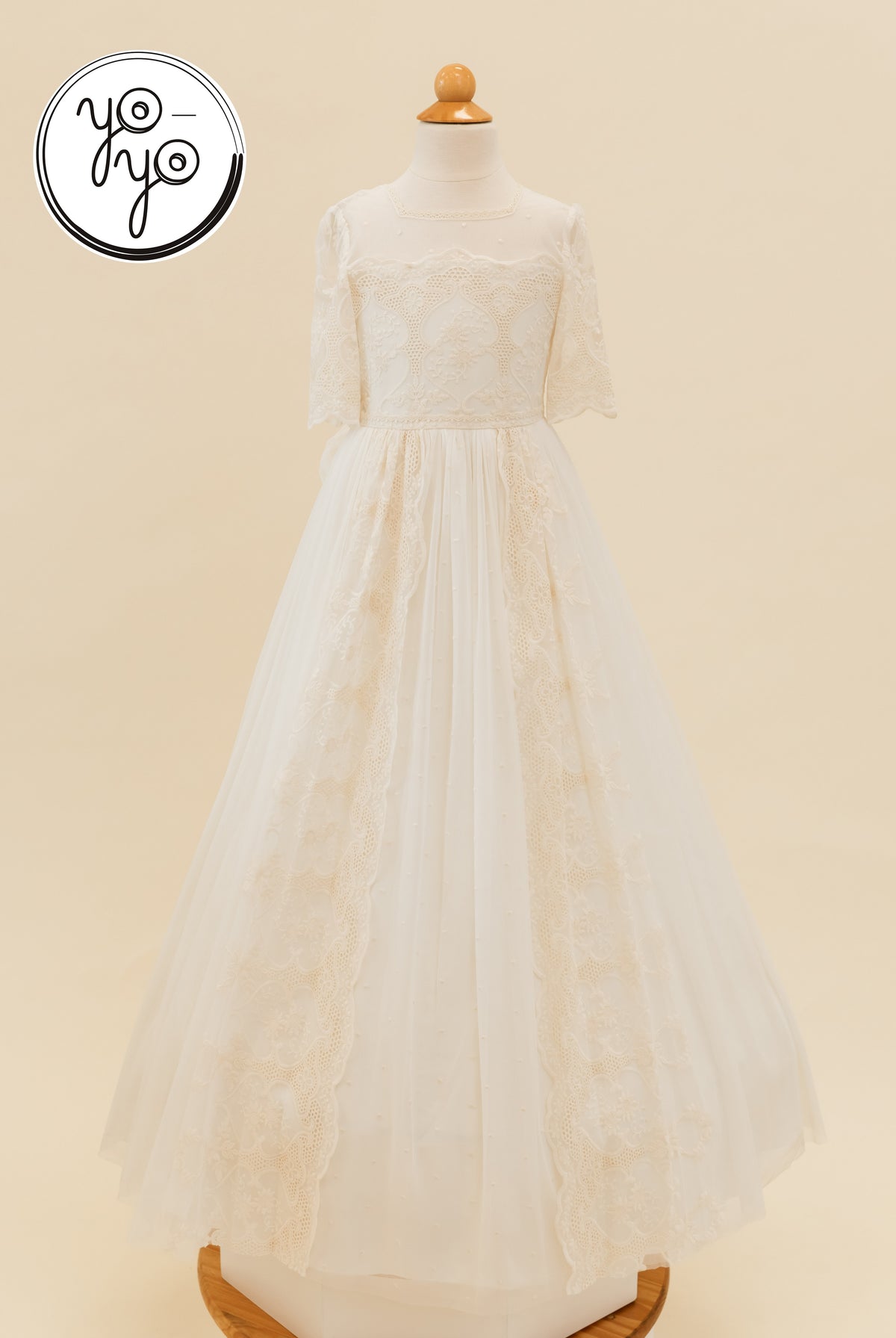 Ivory floor-length Pino dress featuring a sheer lace bodice, elbow-length sleeves, and embroidered French tulle panels.