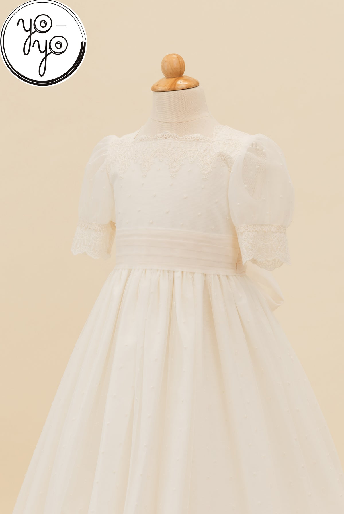 Sophie Dress on a mannequin in ivory French tulle, featuring sheer puff sleeves, a lace-trimmed neckline, and a gathered skirt.