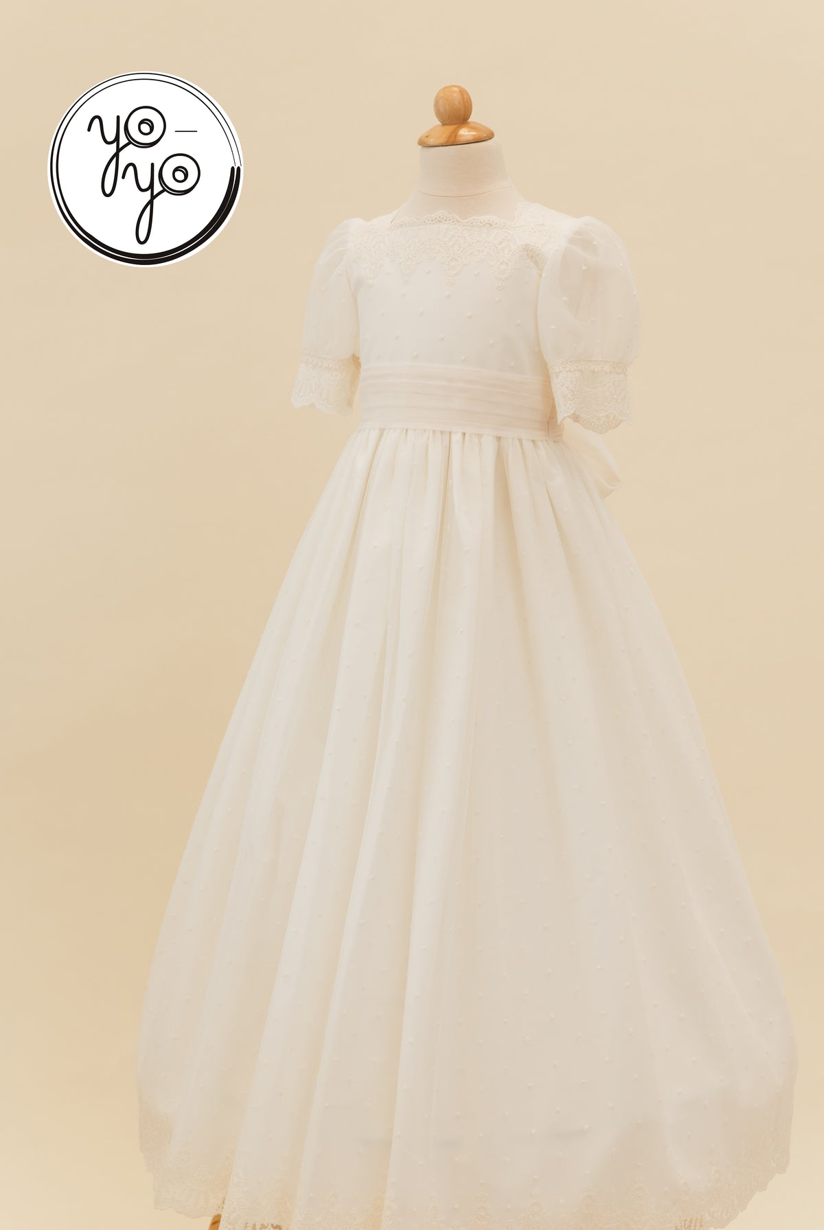 Ivory Sophie dress by YoYo Boutique featuring puff sleeves, a lace-trimmed neckline, and a floor-length Swiss dot skirt.