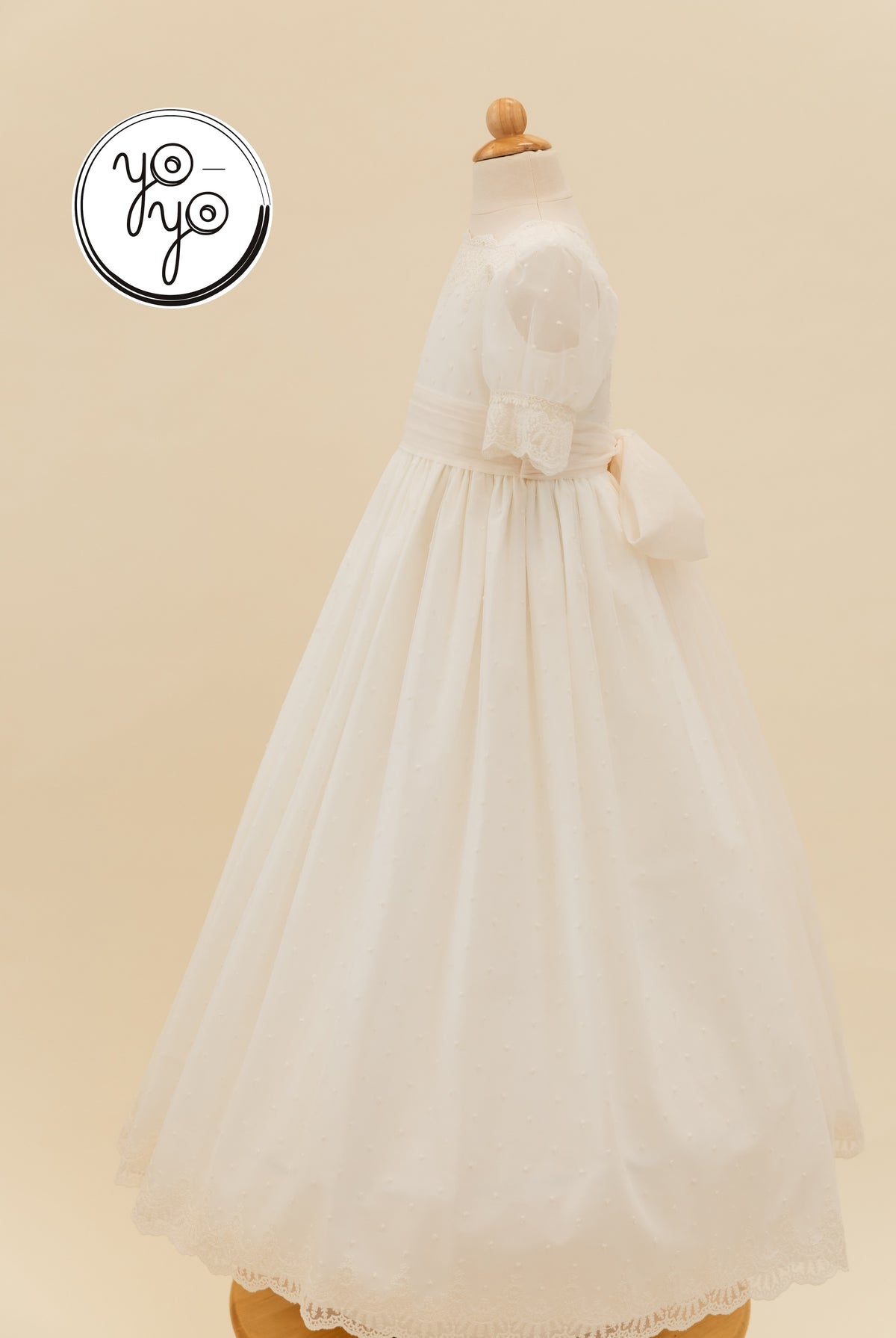 YoYo Boutique Sophie dress in cream French tulle, featuring puffed sleeves, lace trim, and a large waist bow.