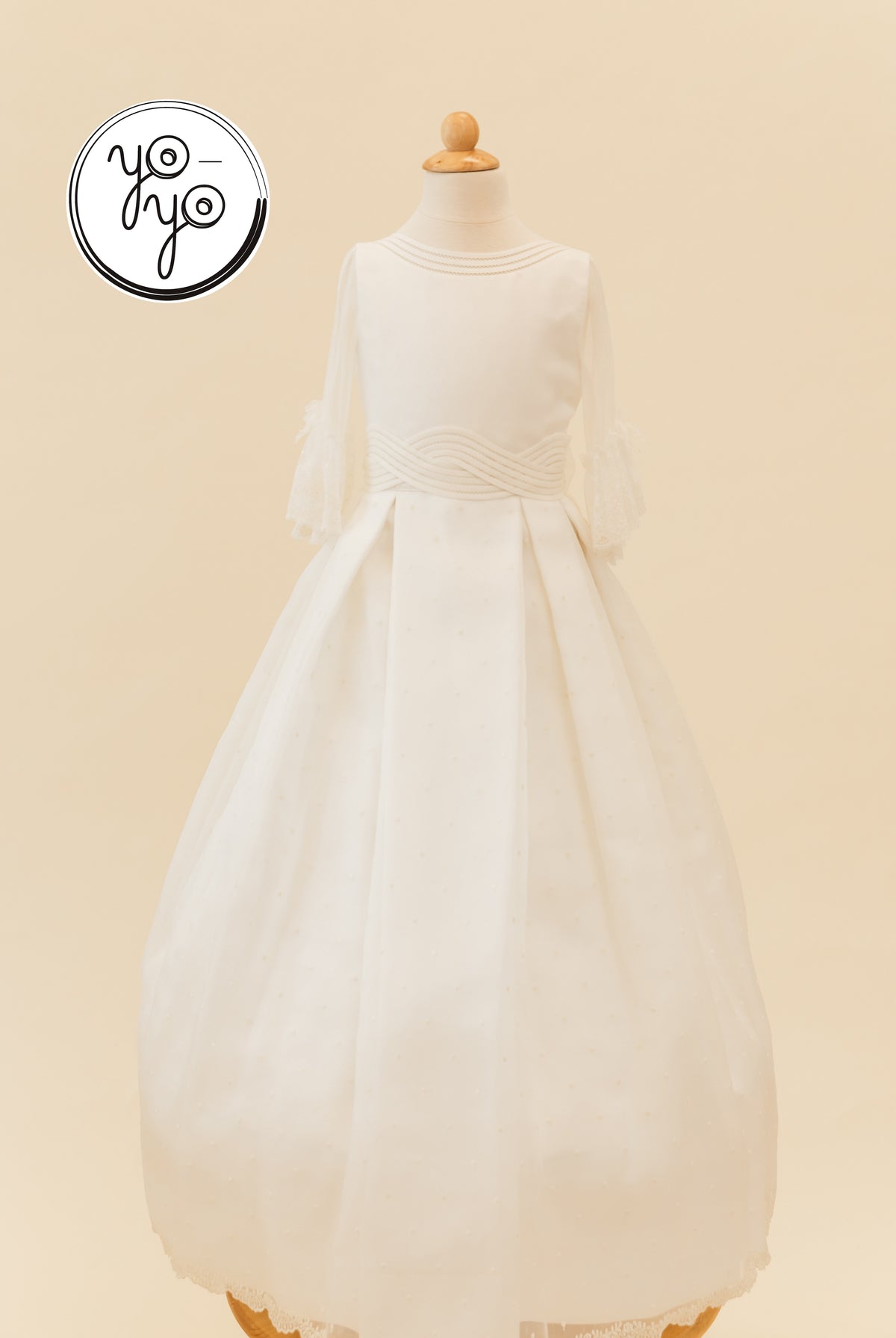Ivory Ceibo dress featuring a round neckline, sheer French sleeves, a pleated skirt, and a wide, textured waistband.