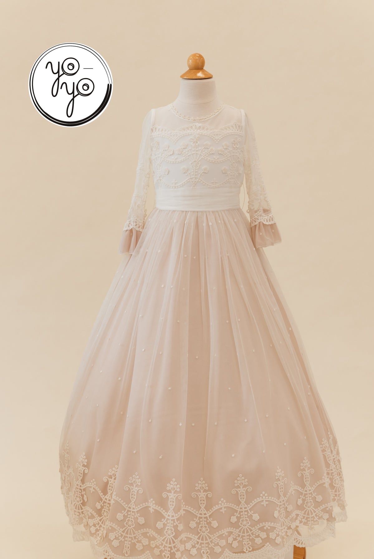 Lua Dress: Floor-length First Communion gown with a white lace bodice, long sleeves, and a tiered dusty rose tulle skirt with pearl accents.