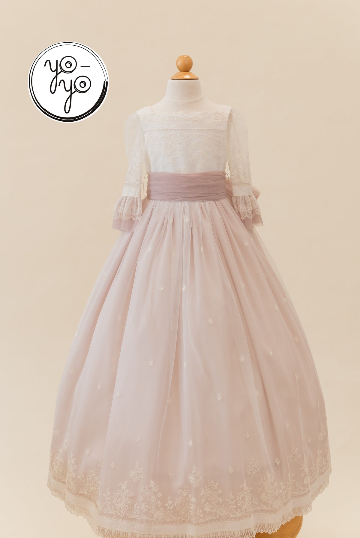 Elena Dress in cream and dusty rose. Boho communion gown with lace sleeves and a full tulle skirt featuring floral embroidery at the hem.