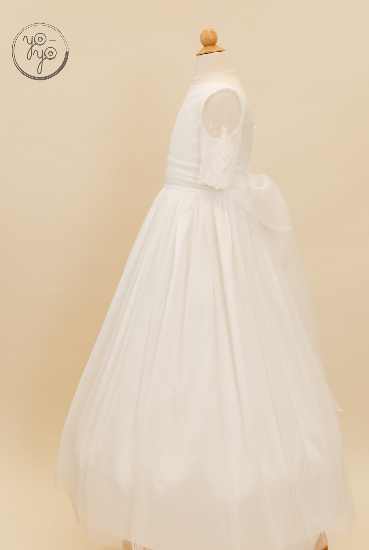 Nigella Dress by YoYo Boutique: white sleeveless First Communion dress featuring a French tulle skirt, lace accents, and a large back waist bow.