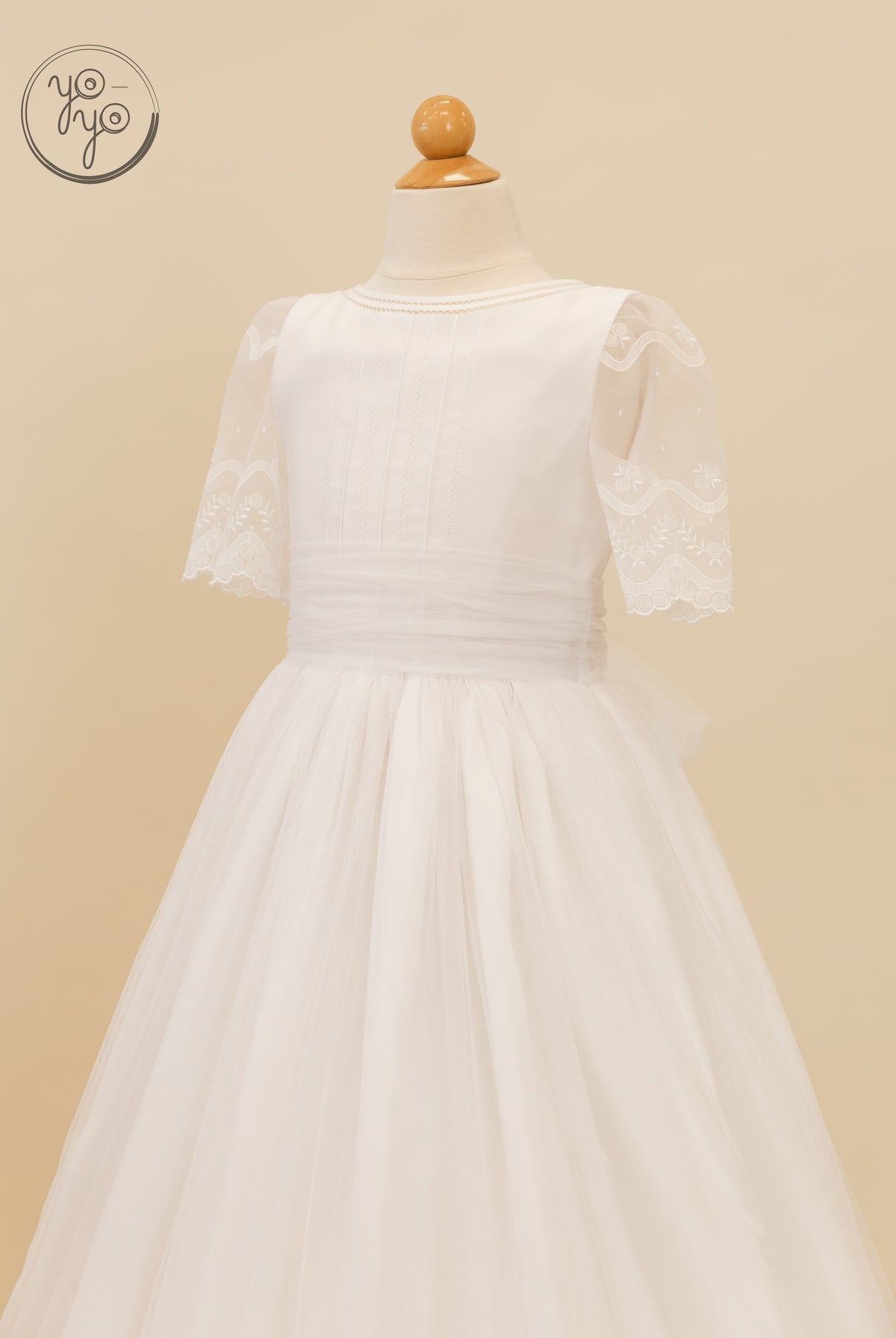 White Lunaria boho dress on a mannequin featuring short sheer lace sleeves and a full tulle skirt.
