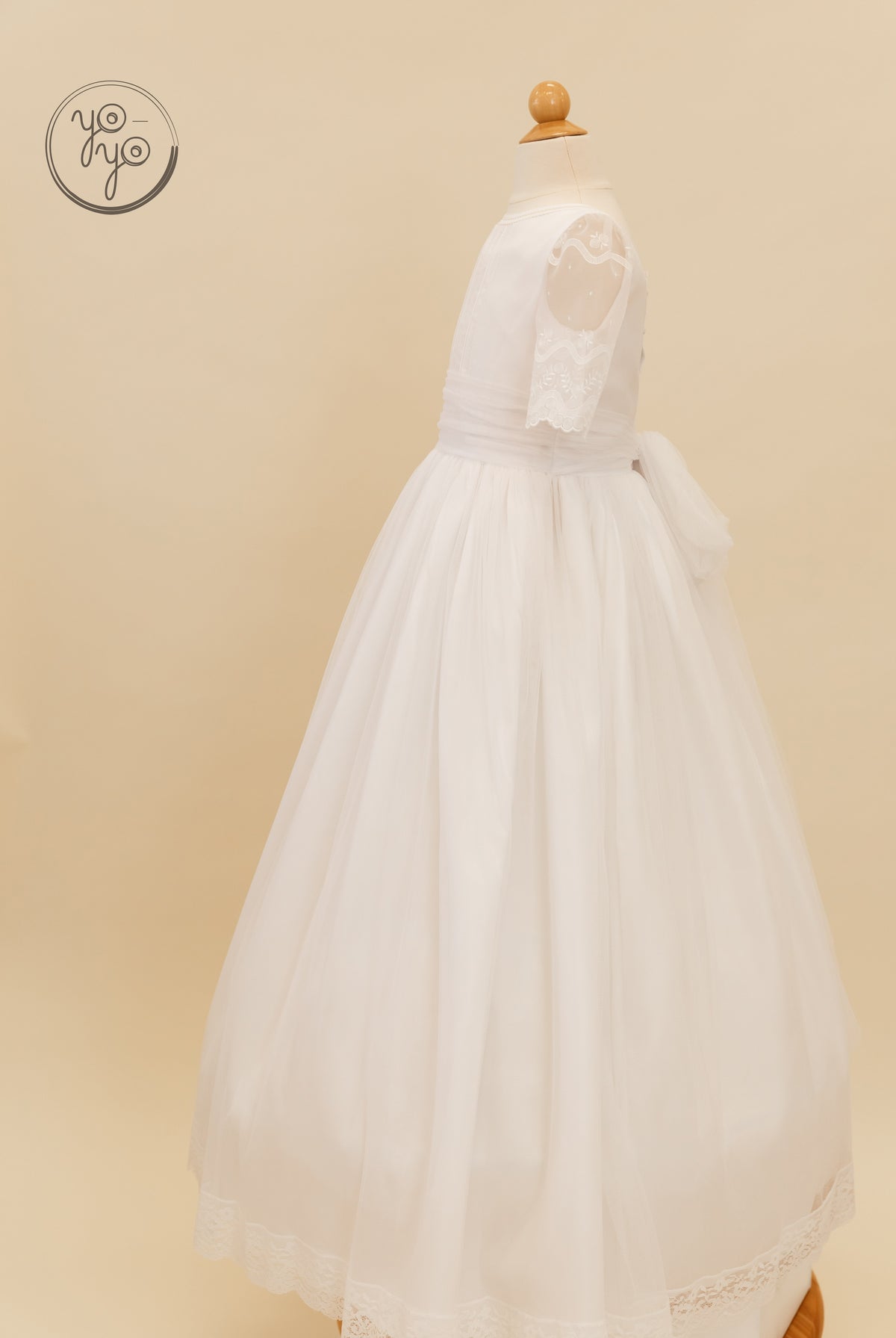Side view of the boho Lunaria Dress on a mannequin, featuring sheer three-quarter sleeves, lace trim, and a tulle skirt.