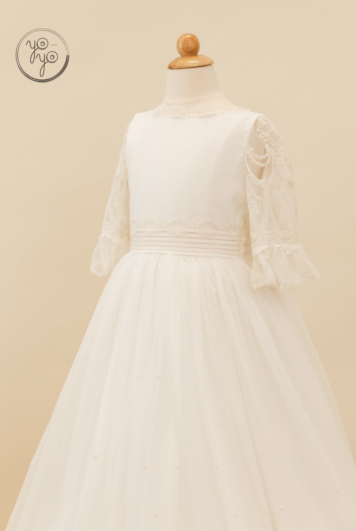 Nerina Dress by YoYo Boutique on a mannequin: a cream boho gown featuring lace sleeves and a French tulle skirt.