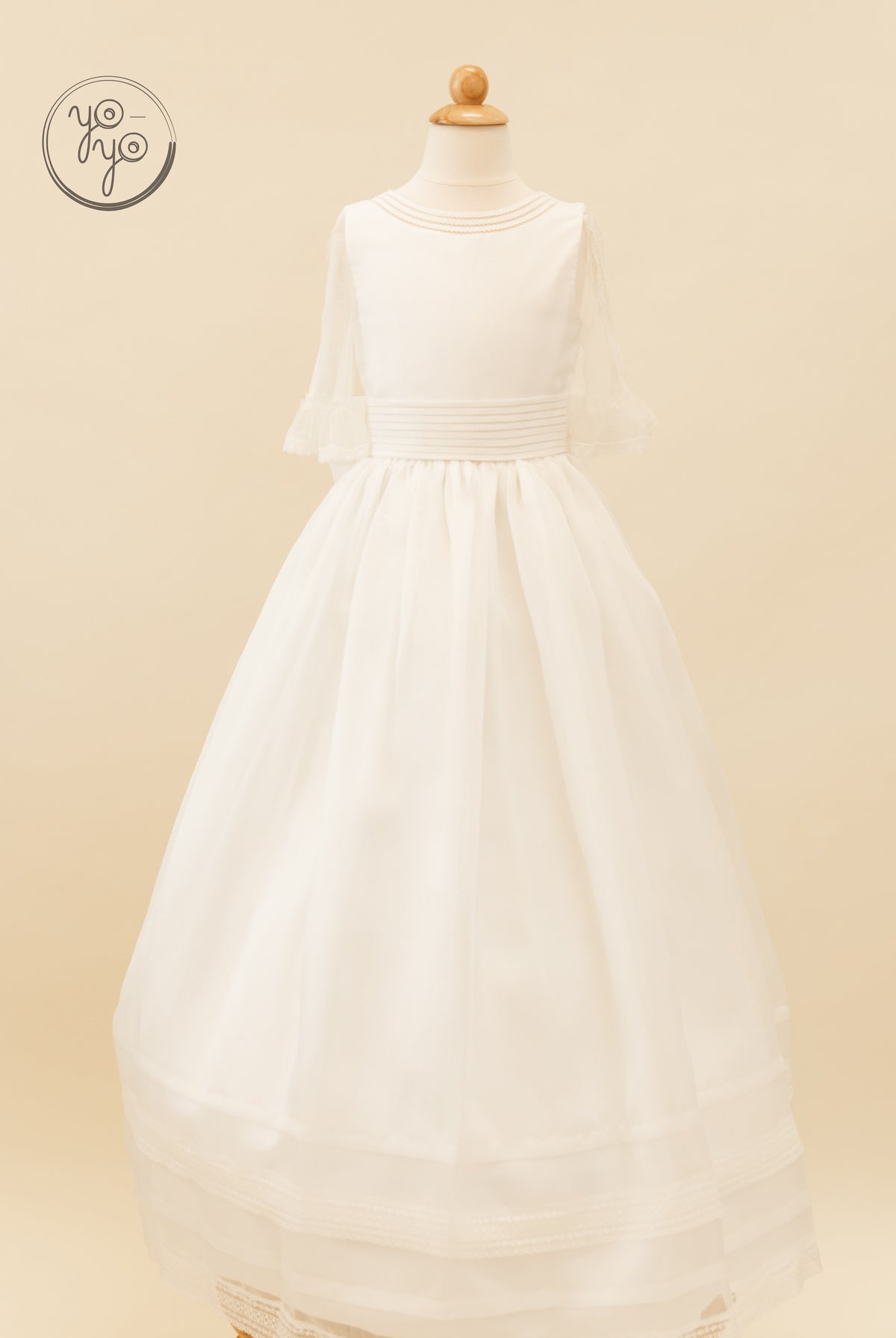 Ivory A-line Jacinto Dress by YoYo Boutique on a mannequin, featuring a round neckline, sheer lace sleeves, and a pleated waistband.