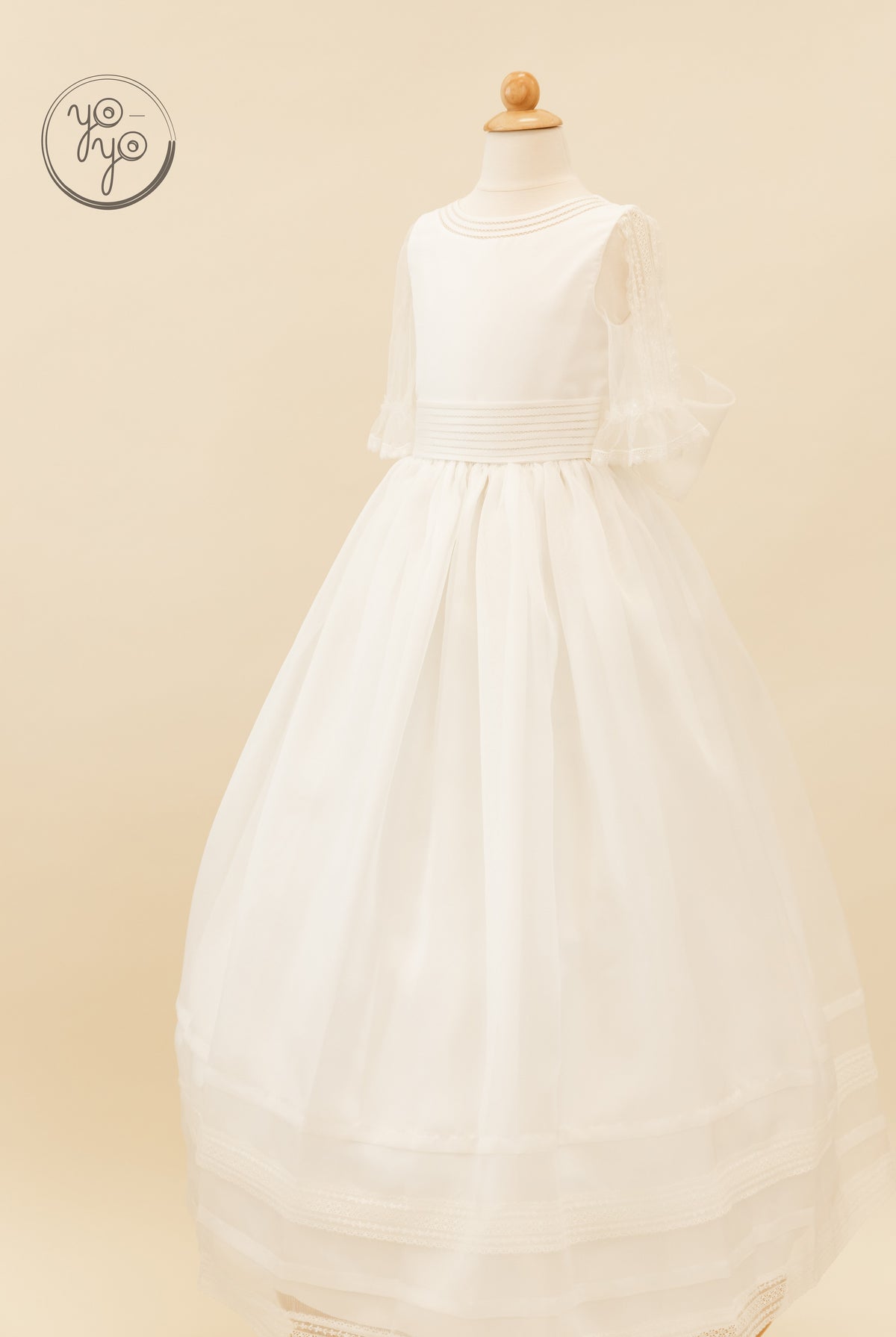 Jacinto Dress by YoYo Boutique: white floor-length boho First Communion dress with sheer 3/4 sleeves, a pleated waist, and a lace hem.