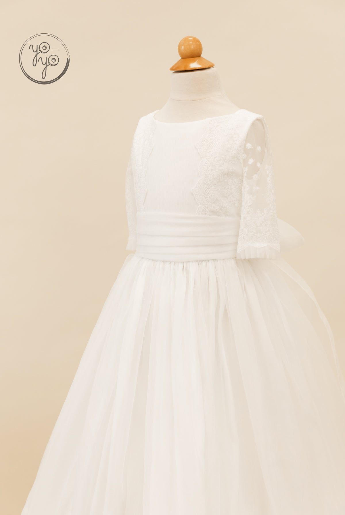 YoYo Boutique Gladiola First Communion dress in white lace organza, featuring a round neckline, three-quarter sleeves, and a wide waistband.