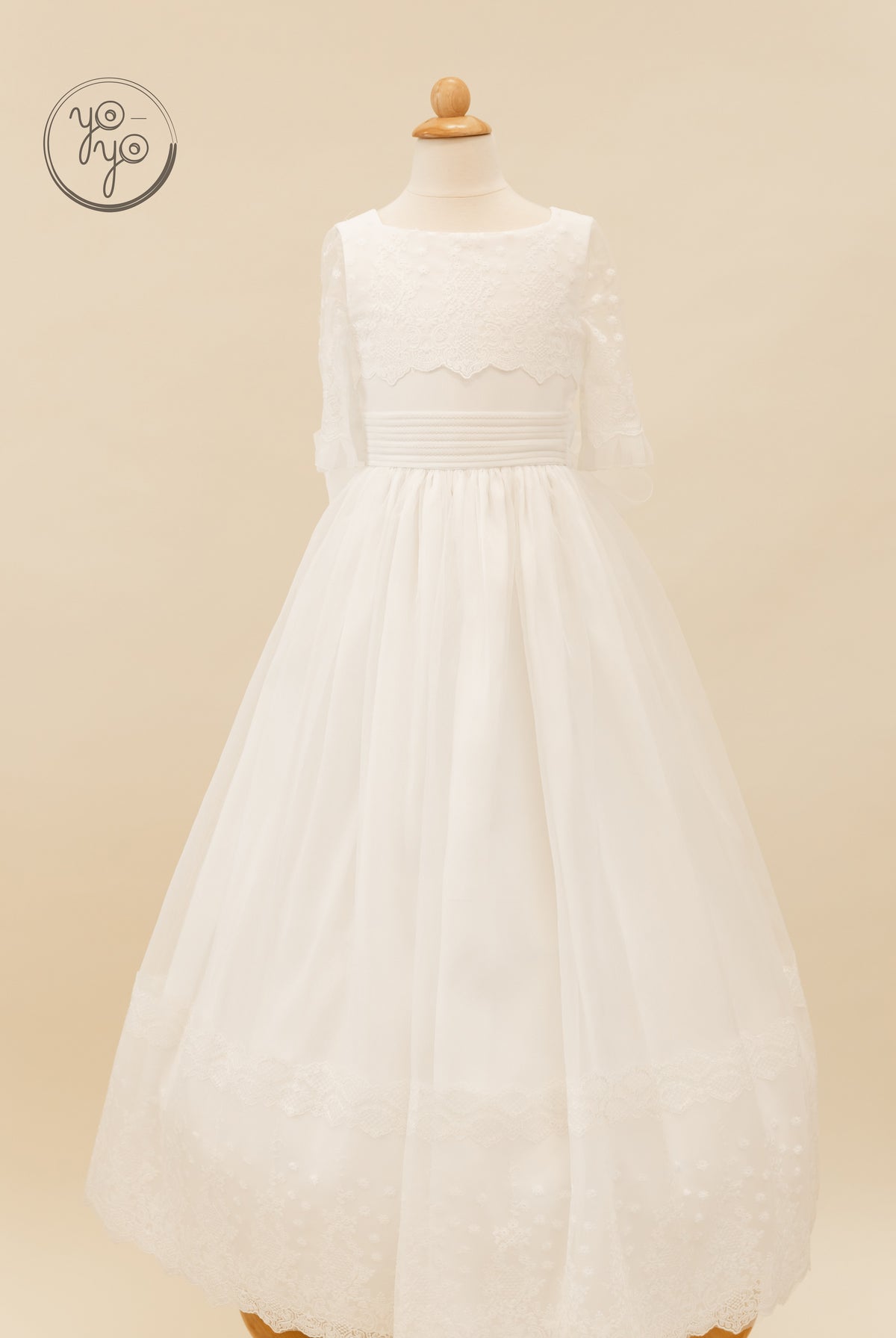 Campanilla Dress: a floor-length boho gown with three-quarter lace sleeves, a wide waistband, and a full skirt with a scalloped embroidered hem.