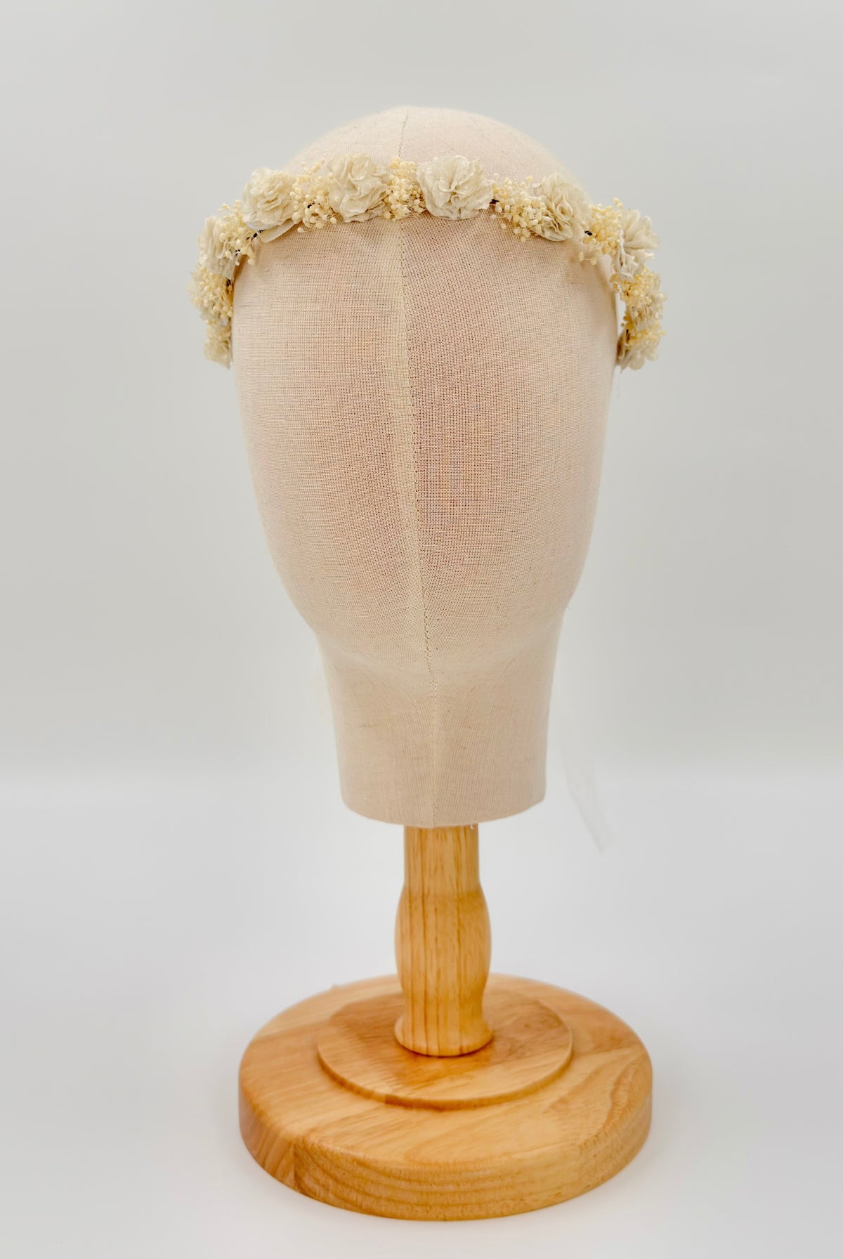 Off-White Flower Headpiece by YoYo Boutique: a handmade headband featuring fabric flowers and dried blossoms on a mannequin head.